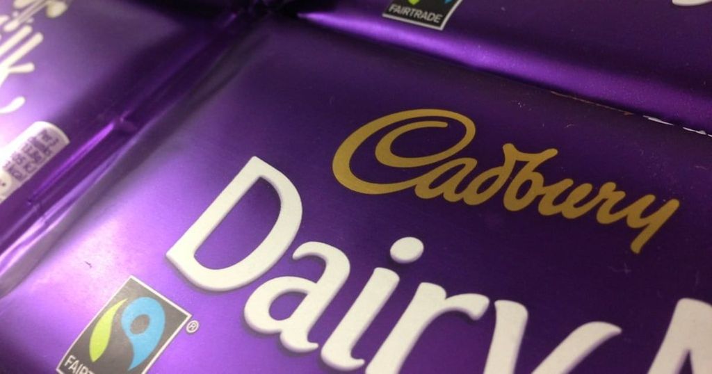 A close-up of a Fairtrade Cadbury Dairy Milk chocolate bar with its logo prominently displayed.