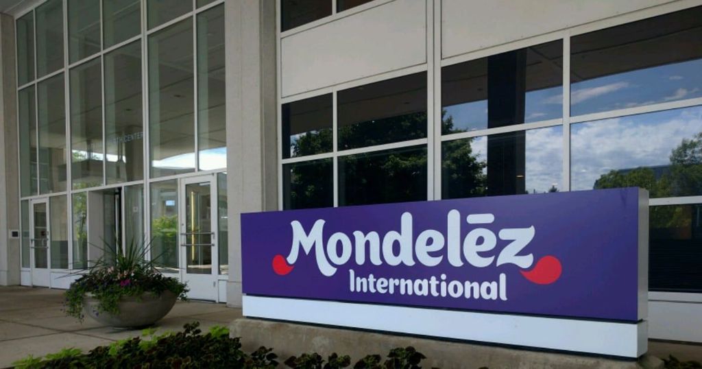 A purple Mondelēz International sign is visible on the exterior of a modern building with large windows.